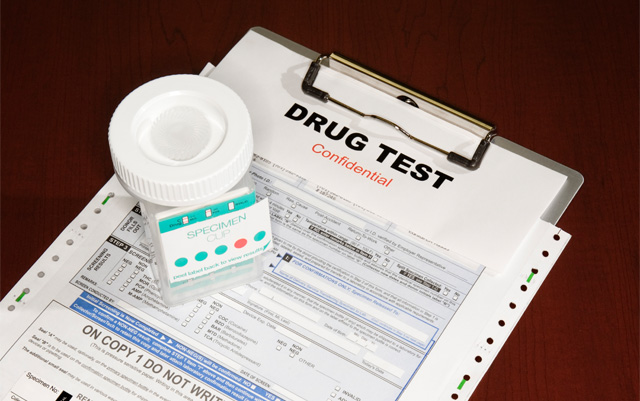Pre-employment drug test specimen cup on a chain-of-custody form